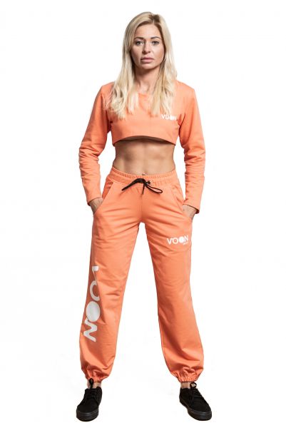 Woman stretching pants coral